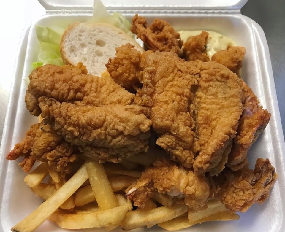 Seafood platters on trays beside fried fish.