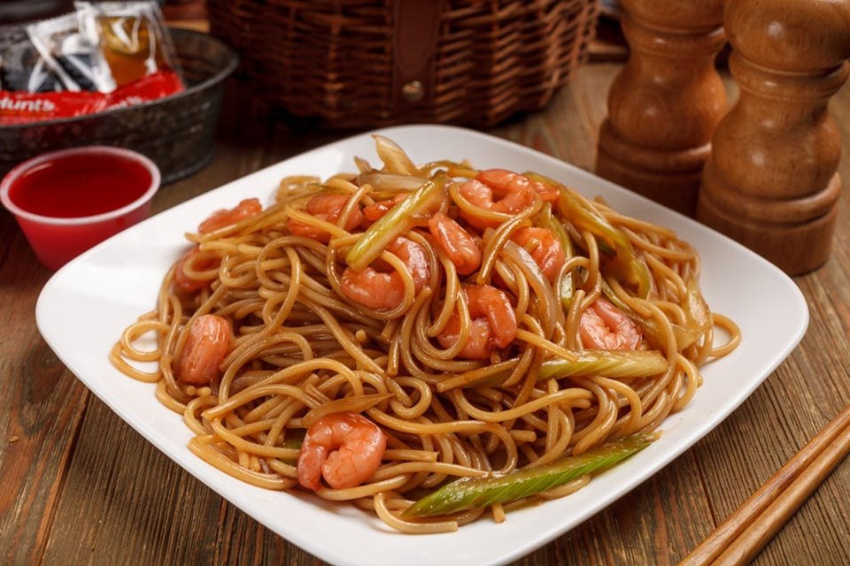 Takeout boxes packed with shrimp and sides.